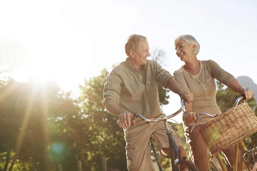 Retired couple riding their bikes and practicing Conscious Thinking