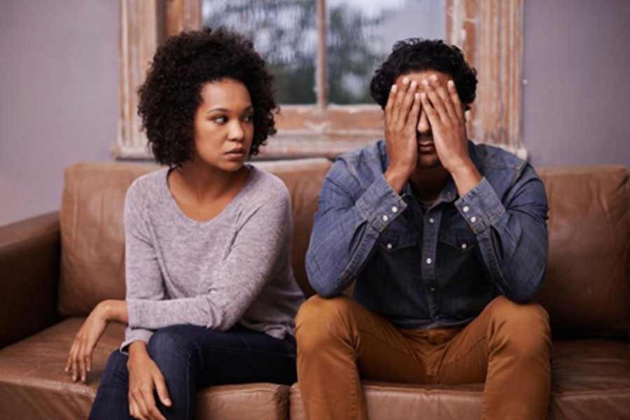 Women sitting next to Man not knowing what is wrong